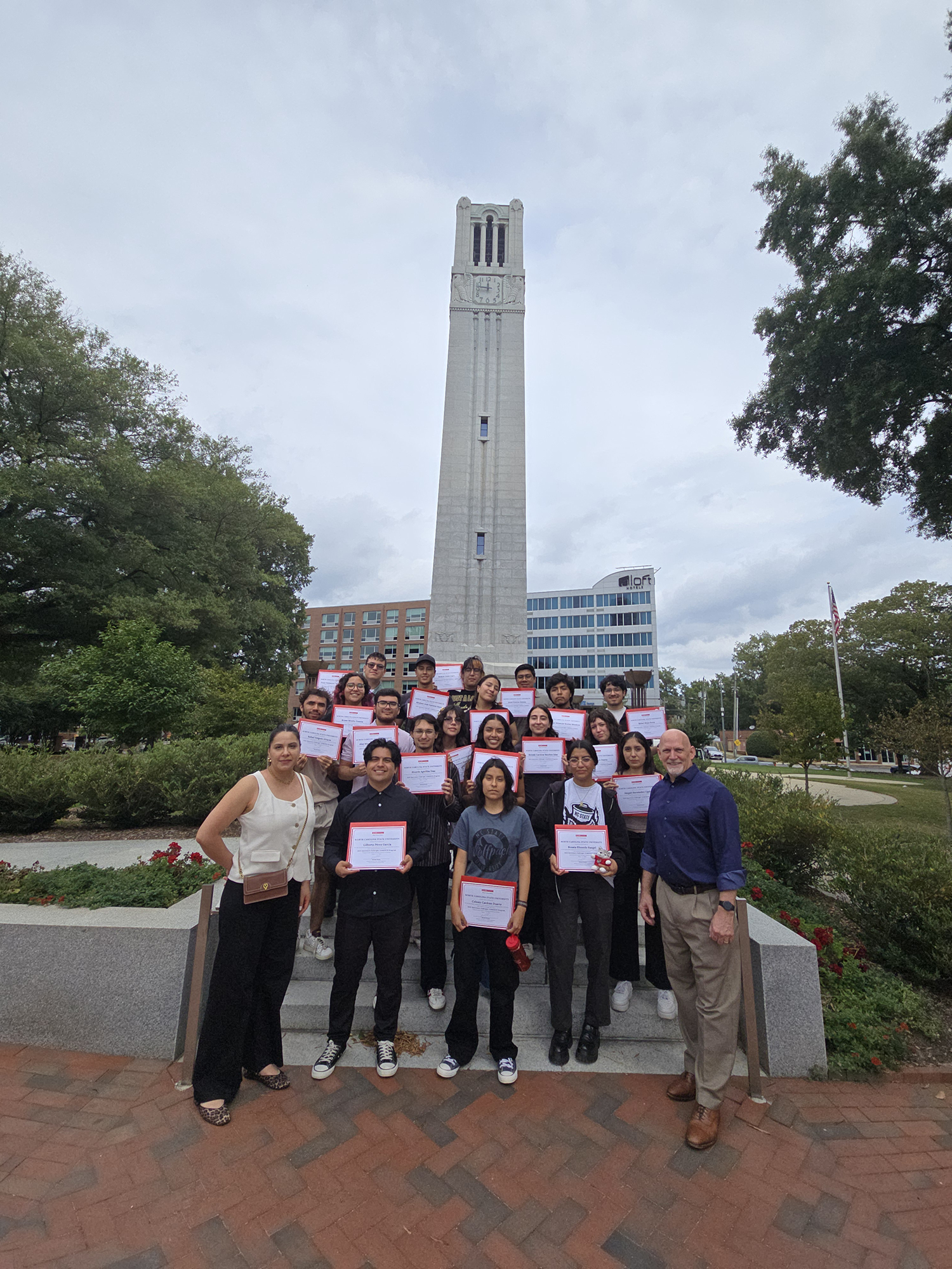 Fulbright Mexico graduation with certificates in front of the Belltower.