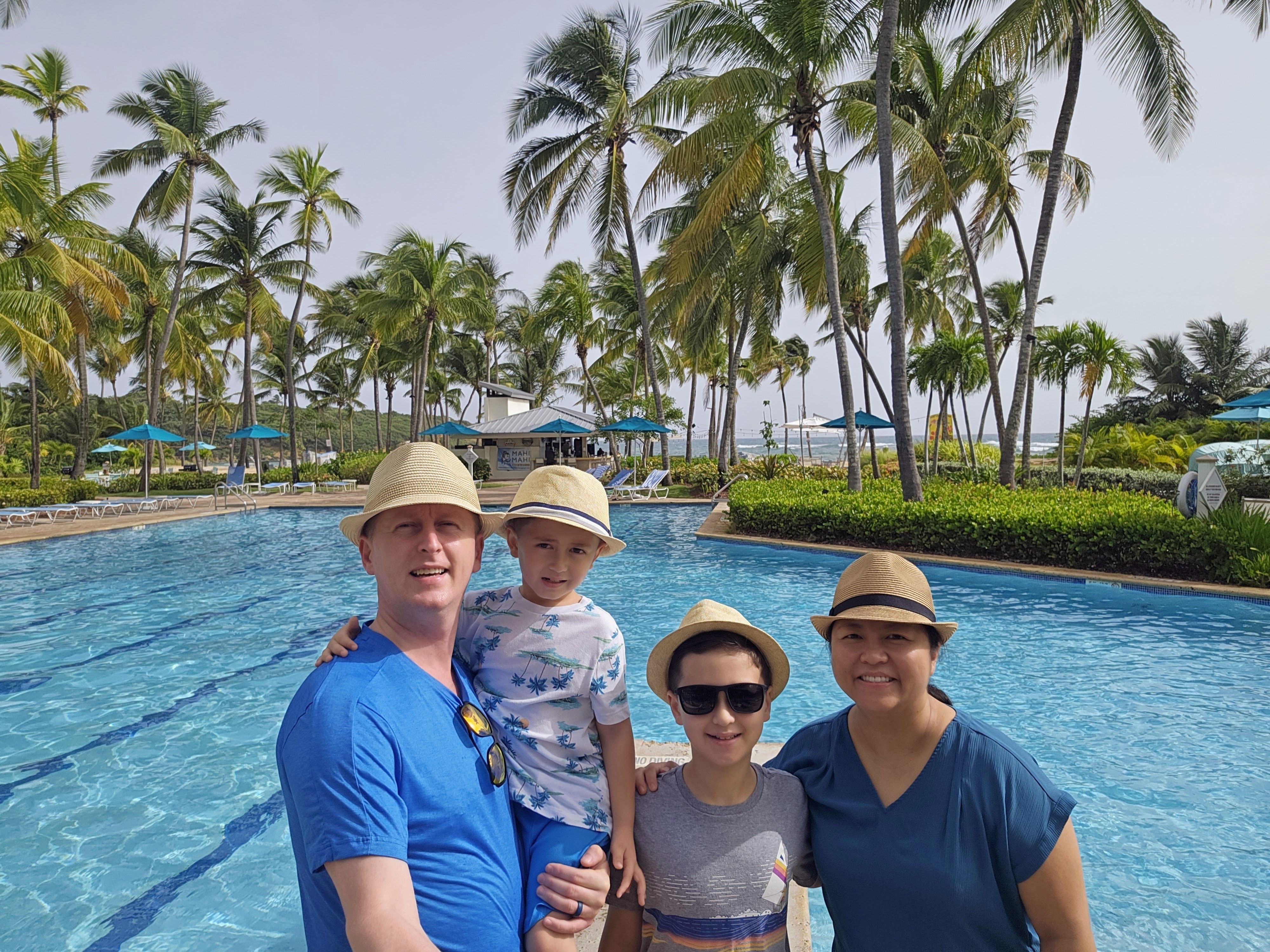 family in front of pool